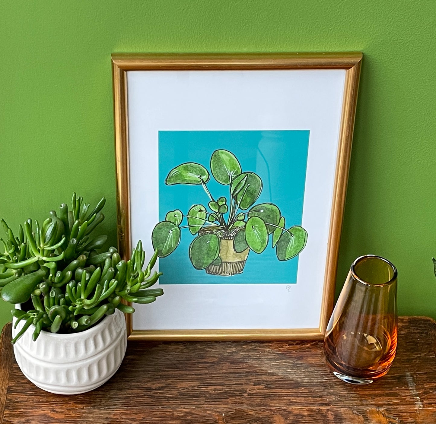 A5 print of a Chinese money plant, or pilea, on a dusky turquoise background 